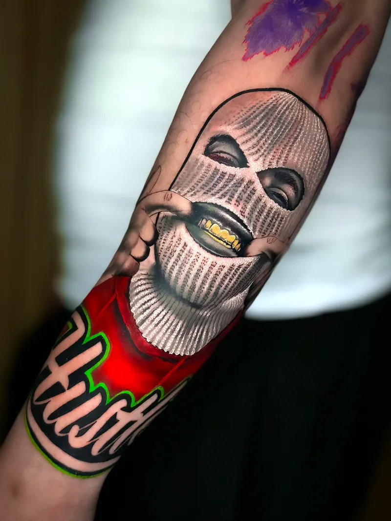 Masked figure forearm tattoo by Deyvid
